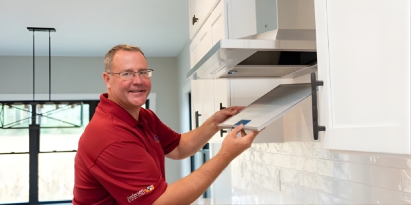 Justin Hurtekant owner Inspired Custom Homes inspecting custom cabinetry