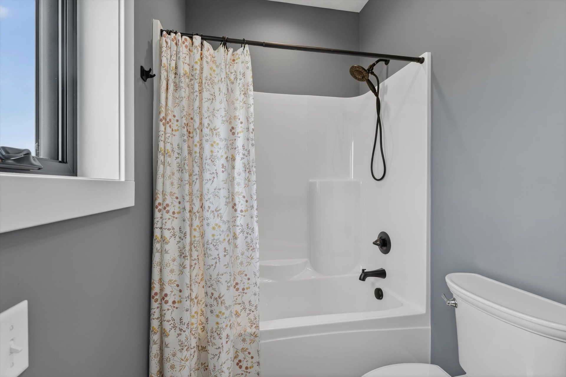 Custom bathroom with tub and shower combo and matte black fixtures